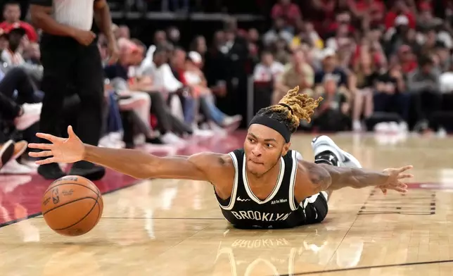 Brooklyn Nets forward Noah Clowney chases the ball during the first half of an NBA basketball game against the Houston Rockets, Monday, Oct. 27, 2025, in Houston. (AP Photo/Karen Warren)