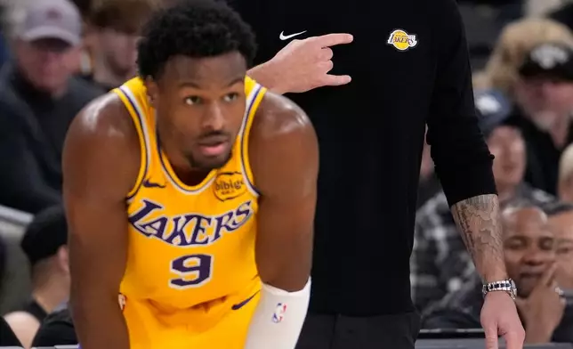 Los Angeles Lakers head coach JJ Redick, right, yells to his team as guard Bronny James stands by during the second half of an NBA preseason basketball game against the Phoenix Suns, Friday, Oct. 3, 2025, in Palm Desert, Calif. (AP Photo/Mark J. Terrill)