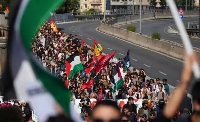 Pro-Palestinian demonstrators march along the Rome's ring road as they gather for a national general strike called by different unions to protest against the situation in Gaza two days after Israeli forces intercepted a Gaza-bound aid flotilla in the Mediterranean Sea, in Rome, Friday, Oct. 3, 2025. (AP Photo/Alessandra Tarantino)