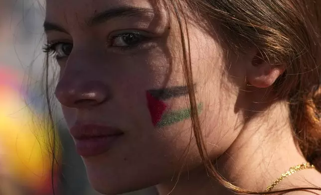 A pro-Palestinian demonstrator gathers for a national general strike called by different unions to protest against the situation in Gaza two days after Israeli forces intercepted a Gaza-bound aid flotilla in the Mediterranean Sea, in Rome, Friday, Oct. 3, 2025. (AP Photo/Alessandra Tarantino)