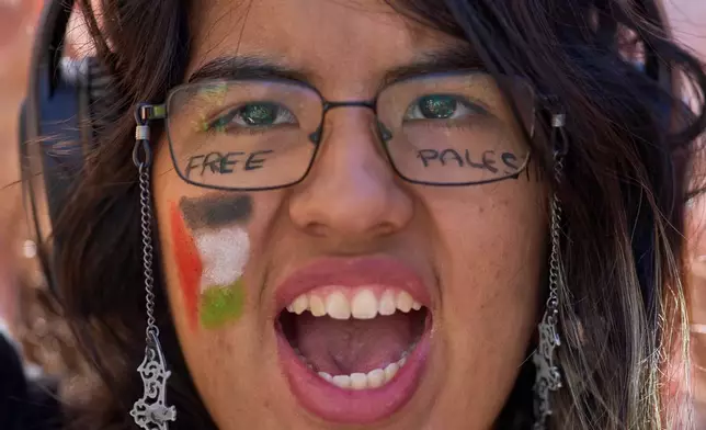 A student with the Palestinian flag painted on her face protests during a pro-Palestinian demonstration in Madrid, Spain, Thursday, Oct. 2, 2025, in solidarity with the Global Sumud Flotilla after ships were intercepted by the Israeli navy. (AP Photo/Manu Fernandez)