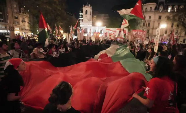 Pro-Palestinian demonstrators protest in Buenos Aires, Argentina, in solidarity with the Global Sumud Flotilla after ships were intercepted by the Israeli navy, Wednesday, Oct. 1, 2025. (AP Photo/Victor R. Caivano)
