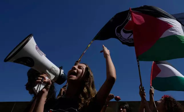A student shouts slogans in front of the Ministry of Foreign Affairs, in Brasilia, Brazil, Thursday, Oct. 2, 2025, during a protest in solidarity with a Gaza-bound flotilla carrying humanitarian aid that was intercepted by Israeli forces. (AP Photo/Eraldo Peres)