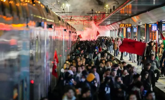 Pro-Palestinian demonstrators flood the rail track at Milan's Cadorna railway station, Italy, late Wednesday, Oct. 1, 2025, after news that a Gaza-bound aid flotilla had been intercepted by Israeli forces in the Mediterranean Sea. (AP Photo/Luca Bruno)