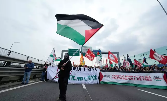 Pro-Palestinian demonstrators march along the Milan's ring road as they gather for a national general strike called by different unions to protest against the situation in Gaza two days after Israeli forces intercepted a Gaza-bound aid flotilla in the Mediterranean Sea, in Milan, Italy, Friday, Oct. 3, 2025. (AP Photo/Luca Bruno)