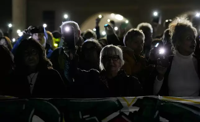 Medical staff stage a flash mob 'Lights on Palestine' to remember the more than 60 thousand Palestinians killed in these last two years by the Israeli army, at the Niguarda Hospital, in Milan, Thursday, Oct. 2, 2025. (AP Photo/Luca Bruno)