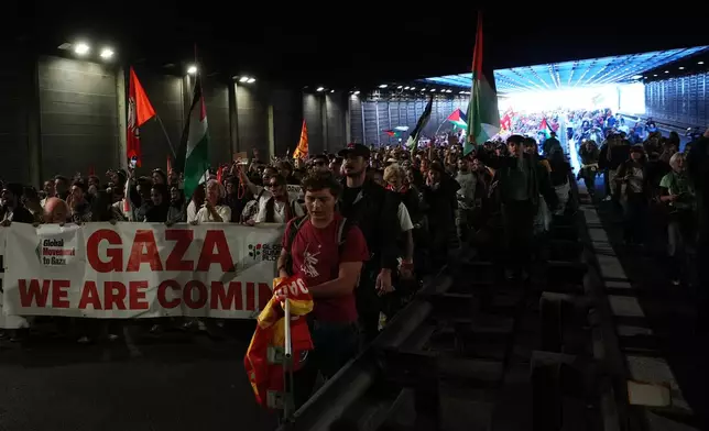 Pro-Palestinian demonstrators march along the Rome's ring road as they gather for a national general strike called by different unions to protest against the situation in Gaza two days after Israeli forces intercepted a Gaza-bound aid flotilla in the Mediterranean Sea, in Rome, Friday, Oct. 3, 2025. (AP Photo/Alessandra Tarantino)