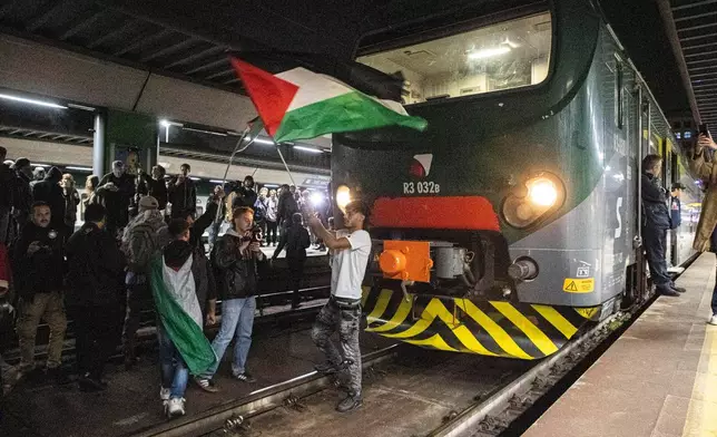 Pro-Palestinian protesters demonstrate at Cadorna train station in solidarity with the Global Sumud Flotilla on Wednesday, Oct. 1, 2025, in Milan, Italy, after ships were intercepted by the Israeli navy. (Marco Ottico/LaPresse via AP)
