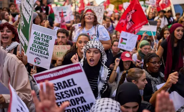 Students protest during a pro-Palestinian demonstration in Madrid, Spain, Thursday, Oct. 2, 2025, in solidarity with the Global Sumud Flotilla after ships were intercepted by the Israeli navy. (AP Photo/Manu Fernandez)