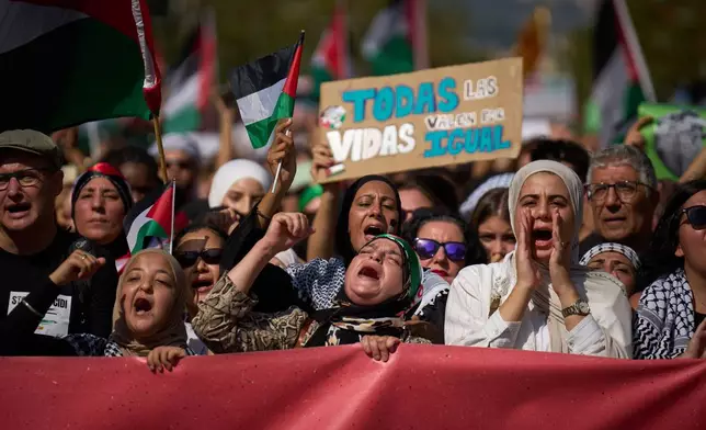 Demonstrators shout slogans as they march during a pro-Palestinian rally in solidarity with the Global Sumud Flotilla after ships were intercepted by the Israeli navy, in Barcelona, Spain, Saturday, Oct. 4, 2025. (AP Photo/Emilio Morenatti)