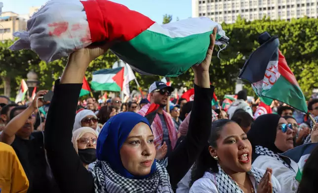 Demonstrators gather for a rally in support of Palestinians and condemning Israel's interception of the Global Sumud Flotilla which was bound for the Gaza Strip, at Avenue Habib Bourguiba, in Tunis, Tunisia, Saturday, Oct. 4, 2025. (AP Photo/Anis Mili)