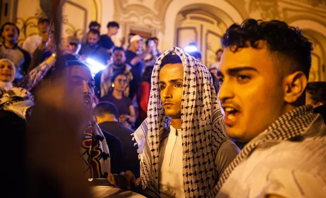 Demonstrators gather in front of the Municipal Theatre during a live screening of the Global Sumud Flotilla and the arrests of its participants by the Israeli army, in Tunis, Tunisia, Thursday, Oct. 2, 2025. (AP Photo/Ons Abid)