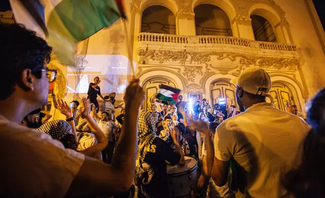 Demonstrators gather in front of the Municipal Theatre during a live screening of the Global Sumud Flotilla and the arrests of its participants by the Israeli army, in Tunis, Tunisia, Thursday, Oct. 2, 2025. (AP Photo/Ons Abid)