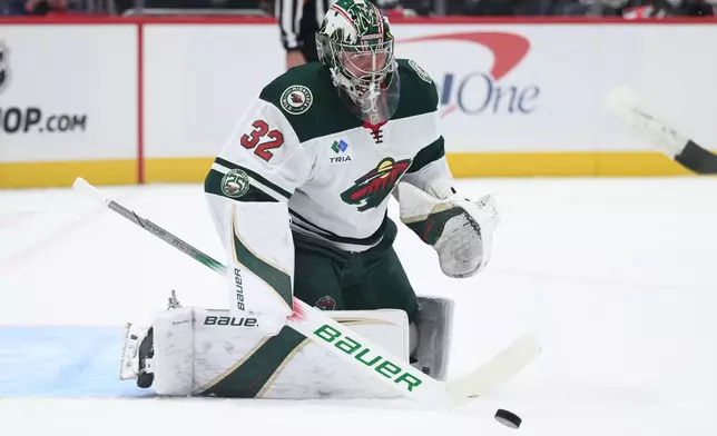Minnesota Wild goaltender Filip Gustavsson watches the puck during the first period of an NHL hockey game against the Washington Capitals, Friday, Oct. 17, 2025, in Washington. (AP Photo/Nick Wass)