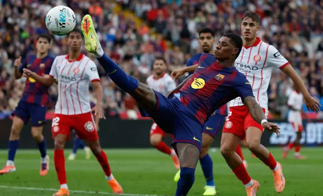 Barcelona's Marcus Rashford shoots during a La Liga soccer match between Barcelona and Girona in Barcelona, Spain, Saturday, Oct. 18, 2025. AP Photo/Joan Monfort)