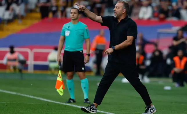Barcelona's head coach Hansi Flick reacts during a La Liga soccer match between Barcelona and Girona in Barcelona, Spain, Saturday, Oct. 18, 2025. AP Photo/Joan Monfort)