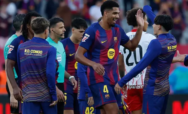 Barcelona players celebrate after a La Liga soccer match between Barcelona and Girona in Barcelona, Spain, Saturday, Oct. 18, 2025. AP Photo/Joan Monfort)