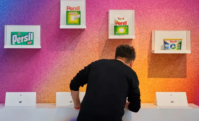 A man smells samples of different historic Persil detergent during the exhibition "The Secret Power of Scents", showing the history of scent from antiquity to the present as a sensory experience at the Kunstpalast art museum in Duesseldorf, Germany, Tuesday, Oct. 28, 2025. (AP Photo/Martin Meissner)