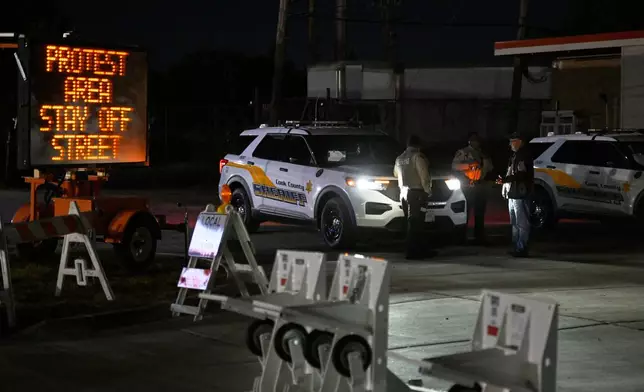 Sheriff's police officers stand near patrol vehicles outside a U.S. Immigration and Customs Enforcement facility in the Chicago suburb of Broadview, Ill., on Wednesday, Oct. 8, 2025. (AP Photo/Paul Beaty)