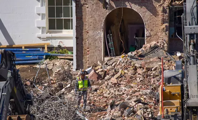 A worker walks through debris at a largely demolished part of the East Wing of the White House, Thursday, Oct. 23, 2025, in Washington, before construction of a new ballroom. (AP Photo/Jacquelyn Martin)