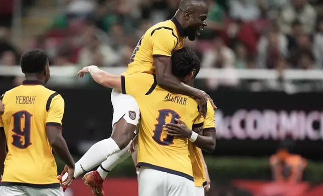 Ecuador's Jordy Alcivar (8) is congratulated after scoring his side's first goal from the penalty spot against Mexico during a friendly soccer match at Akron stadium in Guadalajara, Mexico, Tuesday, Oct. 14, 2025. (AP Photo/Eduardo Verdugo)