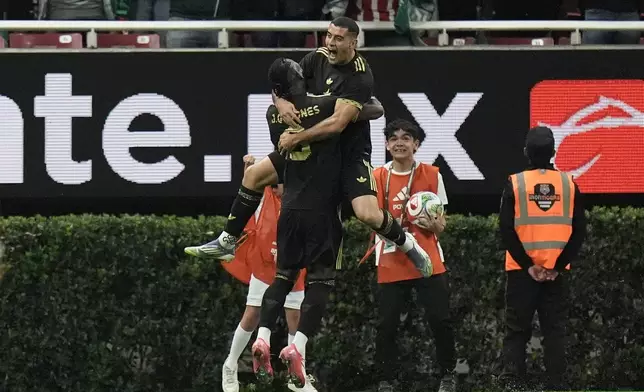 Mexico's Germán Berterame, top, is congratulated after scoring his side's opening goal against Ecuador during a friendly soccer match at Akron stadium in Guadalajara, Mexico, Tuesday, Oct. 14, 2025. (AP Photo/Eduardo Verdugo)