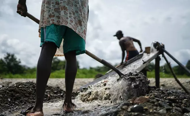 FILE - Small-scale miners look for gold at the Atrato River, in Dona Josefa, Colombia, Sept. 26, 2024. (AP Photo/Ivan Valencia, File)
