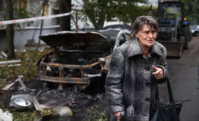An elderly woman reacts next to the house destroyed by a Russian strike in Zaporizhzhia, Ukraine, Sunday, Oct. 5, 2025. (AP Photo/Kateryna Klochko)