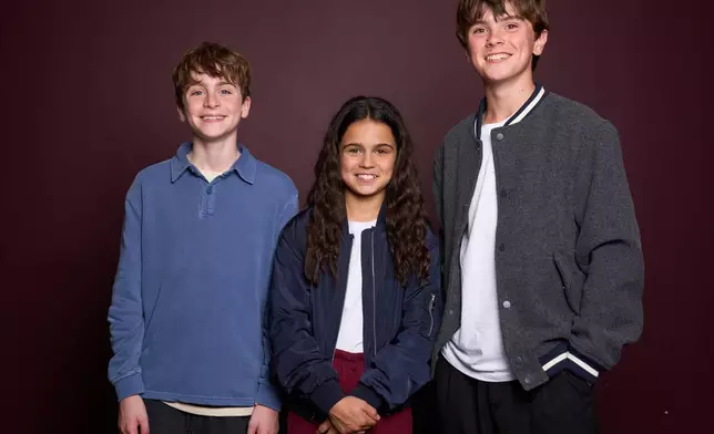 Max Lester, from left, Arabella Stanton and Frankie Treadaway pose for a portrait to promote the Audible "Harry Potter" series in London on July 20, 2025. (Photo by Scott A Garfitt/Invision/AP)