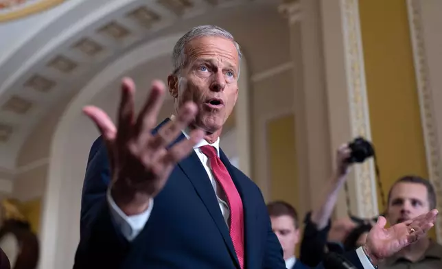 Senate Majority Leader John Thune, R-S.D., gestures while speaking with reporters as the government lurches toward a shutdown at the Capitol in Washington, Tuesday, Sept. 30, 2025. (AP Photo/J. Scott Applewhite)