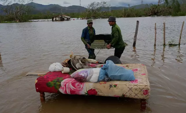 People recover belongings from a home flooded by Hurricane Melissa in Santiago de Cuba, Wednesday, Oct. 29, 2025. (AP Photo/Ramón Espinosa)