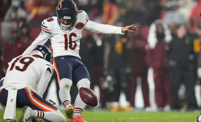 Chicago Bears kicker Jake Moody (16) kicks the game-winning field goal off the hold by punter Tory Taylor as time expires in an NFL football game against the Washington Commanders, Monday, Oct. 13, 2025, in Landover, Md. (AP Photo/Stephanie Scarbrough)