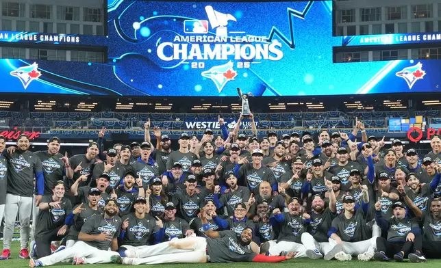 The Toronto Blue Jays pose for a team photo as they celebrate after defeating the Seattle Mariners in MLB American League Championship Series game 7 baseball action in Toronto, Monday, Oct. 20, 2025. (Nathan Denette/The Canadian Press via AP)