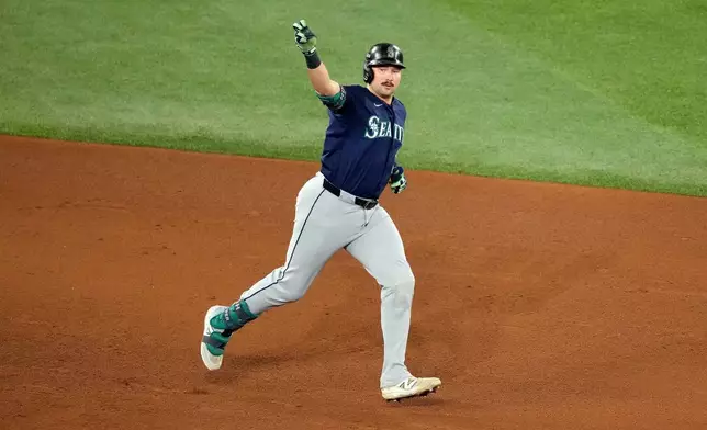 Seattle Mariners' Cal Raleigh celebrates as he rounds the bases after hitting a solo home run against the Toronto Blue Jays during the fifth inning in Game 7 of baseball's American League Championship Series in Toronto, Monday, Oct. 20, 2025. (Chris Young/The Canadian Press via AP)