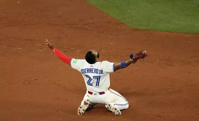 Toronto Blue Jays first baseman Vladimir Guerrero Jr. celebrates after his team's Game 7 win over the Seattle Mariners to take baseball's American League Championship Series in Toronto, Monday, Oct. 20, 2025. (Chris Young/The Canadian Press via AP)