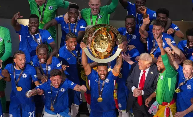 FILE - Chelsea pleayers celebrate with the championship trophy after the Club World Cup final soccer match between Chelsea and PSG in East Rutherford, N.J., Sunday, July 13, 2025. (AP Photo/Matt Slocum, File)