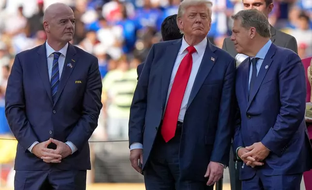 FILE - President Donald Trump, center, talks with Chelsea football club owner Todd Boehly, right, as FIFA president Gianni Infantino, left, looks on before the trophy ceremony of the Club World Cup final soccer match in East Rutherford, N.J., Sunday, July 13, 2025. (AP Photo/Frank Franklin II, File)