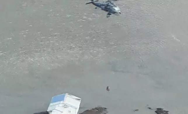 In this photo provided by the Defense Visual Information Distribution Service, Alaska Air National Guard rescue personnel conduct a search and rescue mission in Kipnuk, Alaska, on Monday, Oct. 13, 2025. (Defense Visual Information Distribution Service via AP)