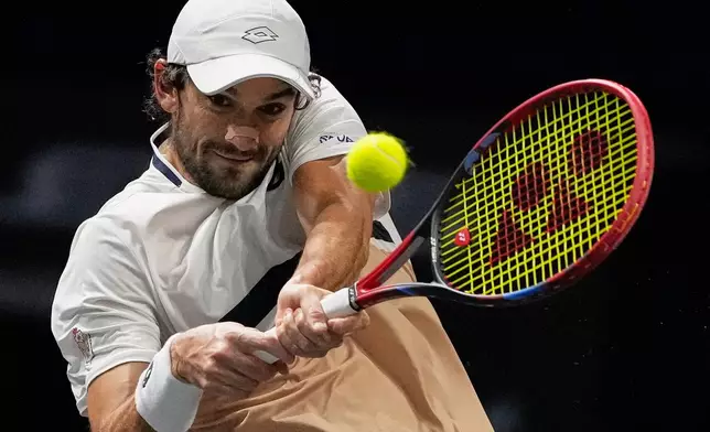 Vacherot of Monaco serves the ball to Cameron Norrie of Great Britain during their third round men's singles match at the Paris Masters tennis tournament at the Paris La Defense Arena, Thursday, Oct. 30, 2025, in Paris. (AP Photo/Michel Euler)