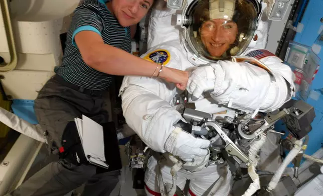 In this photo provided by NASA on Friday, Oct. 4, 2019, astronauts Christina Koch, right, and, Jessica Meir pose for a photo on the International Space Station. (NASA via AP)