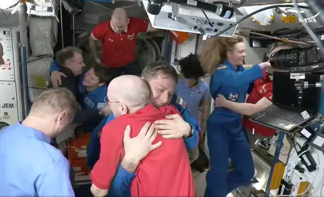 FILE - In this image from video provided by NASA, astronaut Don Pettit, bottom center, hugs Kirill Peskov as astronauts greet each other after a SpaceX capsule docked with the International Space Station, Sunday, March 16, 2025. (NASA via AP, File)
