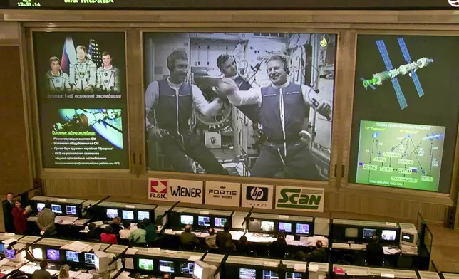 FILE - Russia's Mission Control center monitors the crew floating inside the International Space Station, from at Korolyov, just outside Moscow, Thursday, Nov. 2, 2000. The central screen shows American astronaut Bill Shepherd, right, Russian cosmonauts Yuri Gidzenko, center, and Sergei Krikalev, left. (AP Photo/Mikhail Metzel, File)
