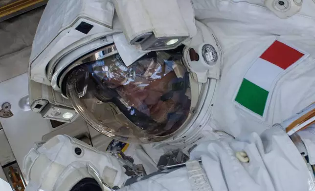In this photo provided by NASA, European Space Agency astronaut Luca Parmitano, Expedition 36 flight engineer, participates in a spacewalk outside the International Space Station on July 16, 2013, before he reported water floating behind his head inside his helmet. (NASA via AP)