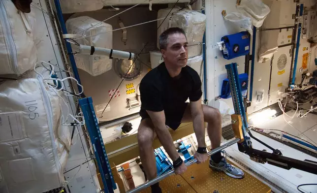 FILE - In this photo made available by NASA, astronaut Chris Cassidy, Expedition 36 flight engineer, exercises on the advanced Resistive Exercise Device (aRED) in the Tranquility node of the International Space Station on Aug. 31, 2013. (NASA via AP, File)