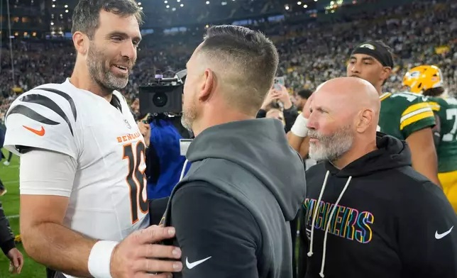 Cincinnati Bengals' Joe Flacco speaks with Green Bay Packers head coach Matt Lafleur after an NFL football game, Sunday, Oct. 12, 2025, in Green Bay, Wis. (AP Photo/Morry Gash)