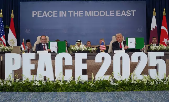 President Donald Trump and Egypt's President Abdel-Fattah el-Sissi hold signed documents during a summit to support ending the more than two-year Israel-Hamas war in Gaza after a breakthrough ceasefire deal, Monday, Oct. 13, 2025, in Sharm El Sheikh, Egypt. (AP Photo/Evan Vucci)