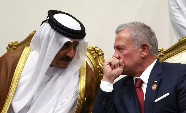 Emir of Qatar Sheikh Tamim ibn Hamad Al Thani and Jordan's King Abdullah, right, meet before attending a world leaders' summit on ending the Gaza war, in Sharm el-Sheikh, Egypt, Monday, Oct. 13, 2025. (Suzanne Plunkett, Pool Photo via AP)