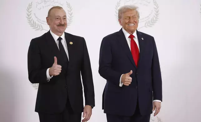 Azerbaijani President Ilham Aliyev and President Donald Trump pose during the greetings ceremony before the family picture at the Gaza International Peace Summit, in Sharm el-Sheikh, Egypt, Monday, Oct.13 2025. (Yoan Valat, Pool photo via AP)