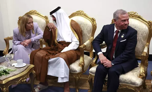 From left, Italy's Prime Minister Giorgia Meloni, Emir of Qatar Sheikh Tamim ibn Hamad Al Thani and Jordan's King Abdullah meet before attending a world leaders' summit on ending the Gaza war, in Sharm el-Sheikh, Egypt, Monday, Oct. 13, 2025. (Suzanne Plunkett, Pool Photo via AP)