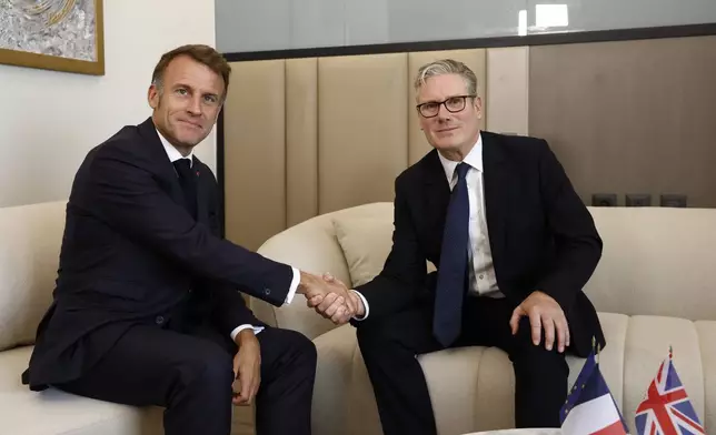 French President Emmanuel Macron, left, attends a bilateral meeting with British Prime Minister Keir Starmer on the sidelines of the Gaza International Peace Summit, in Sharm el-Sheikh, Egypt, Monday, Oct.13 2025. (Yoan Valat, Pool photo via AP)